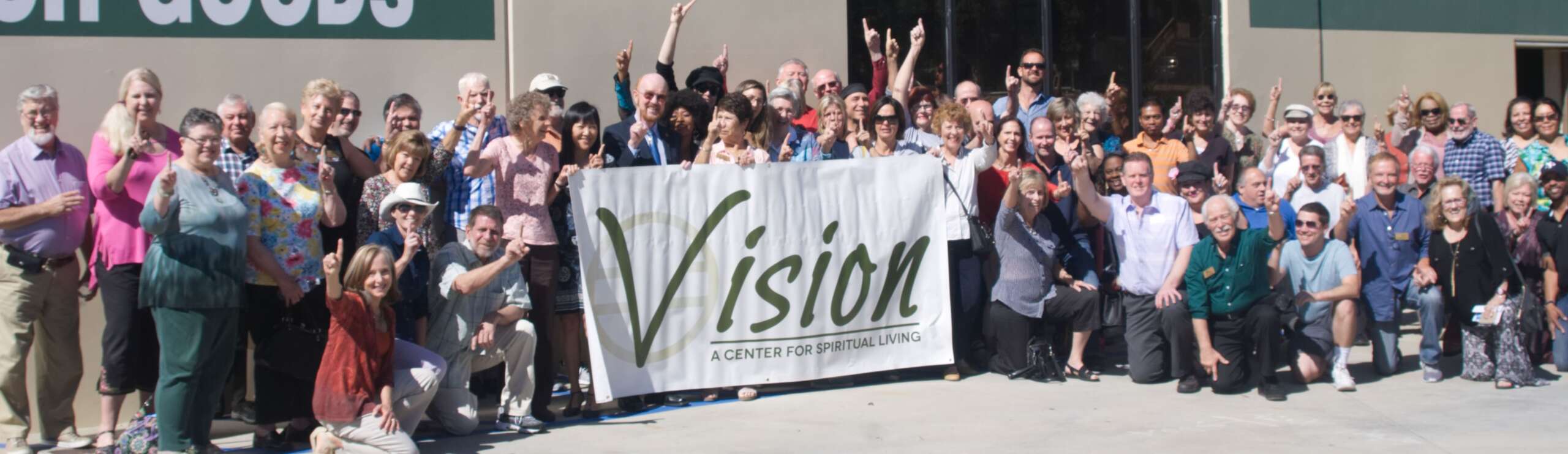 Group of people holding a banner with the word ‘Vision’. Group of people holding a banner with the word 'Vision'.