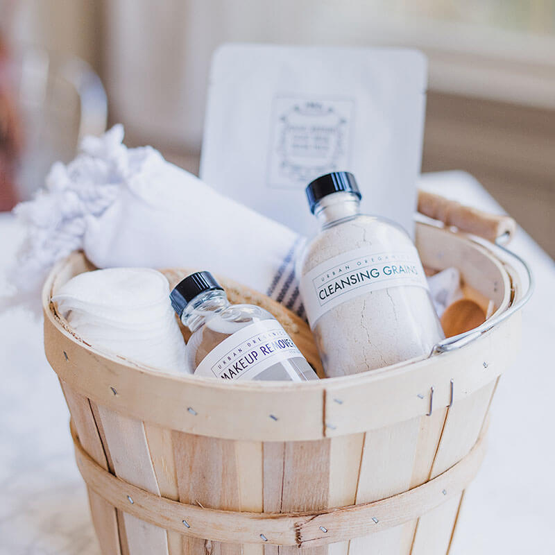 Basket with skincare essentials including makeup remover and cleansing grains. Basket with skincare essentials including makeup remover and cleansing grains.